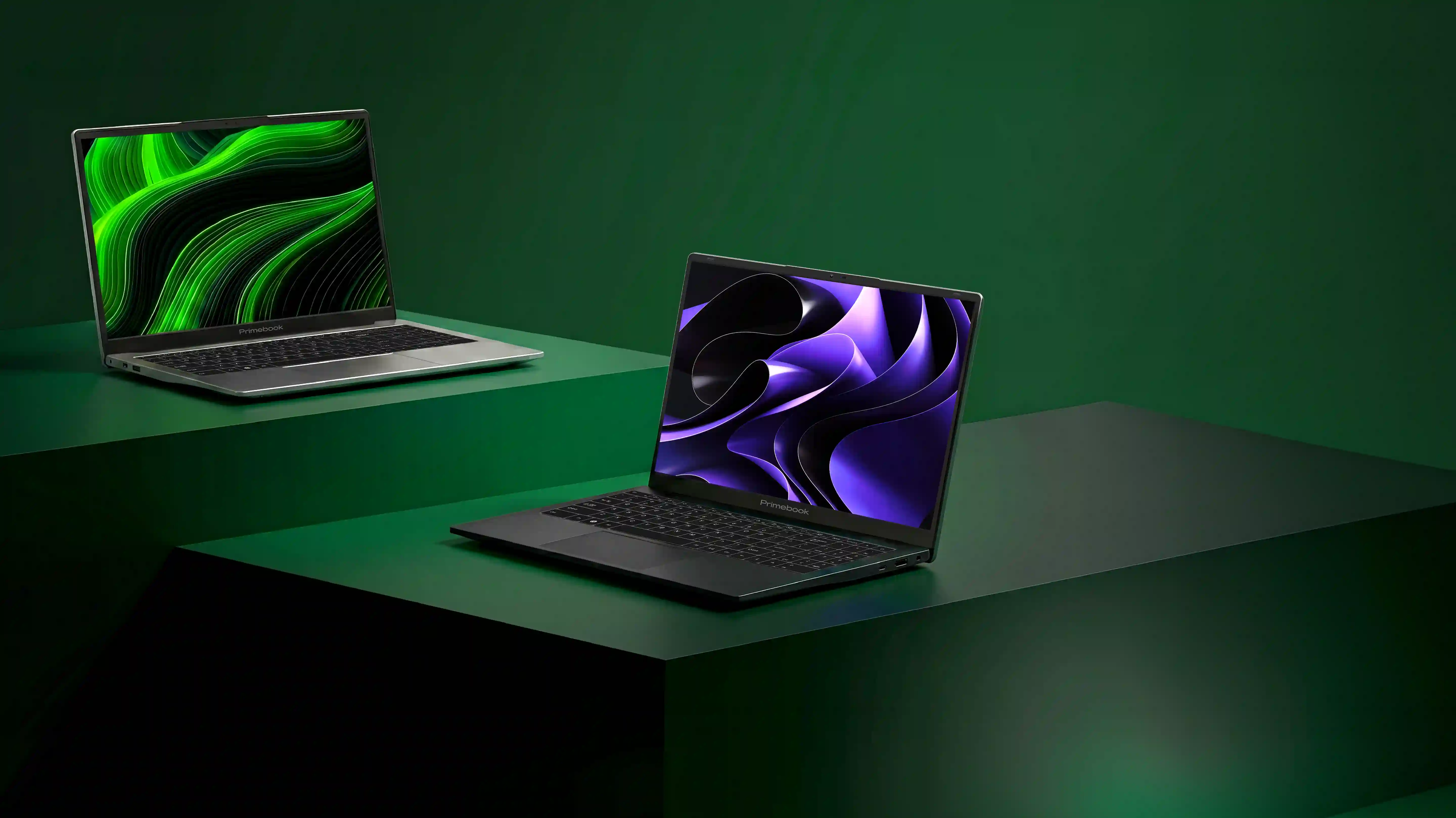 Two Primebook laptops on neon green pedestals
